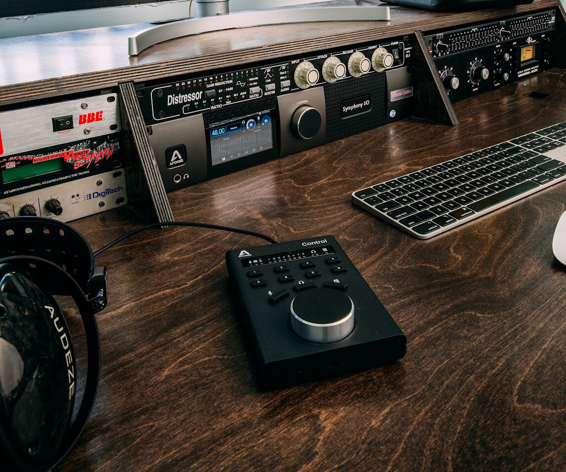 Apogee Control USB Remote next to Symphony I/O Mk II on a desk