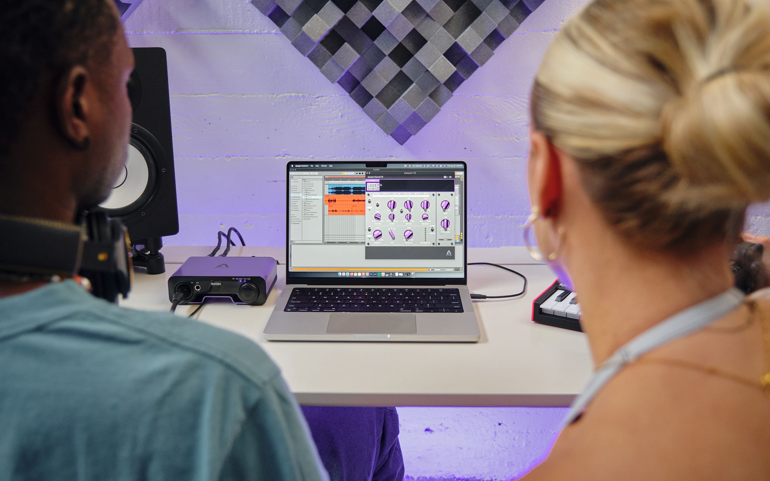 A young girl and guy producing music using Apogee's BOOM. As part of the Apogee's Edu Program.